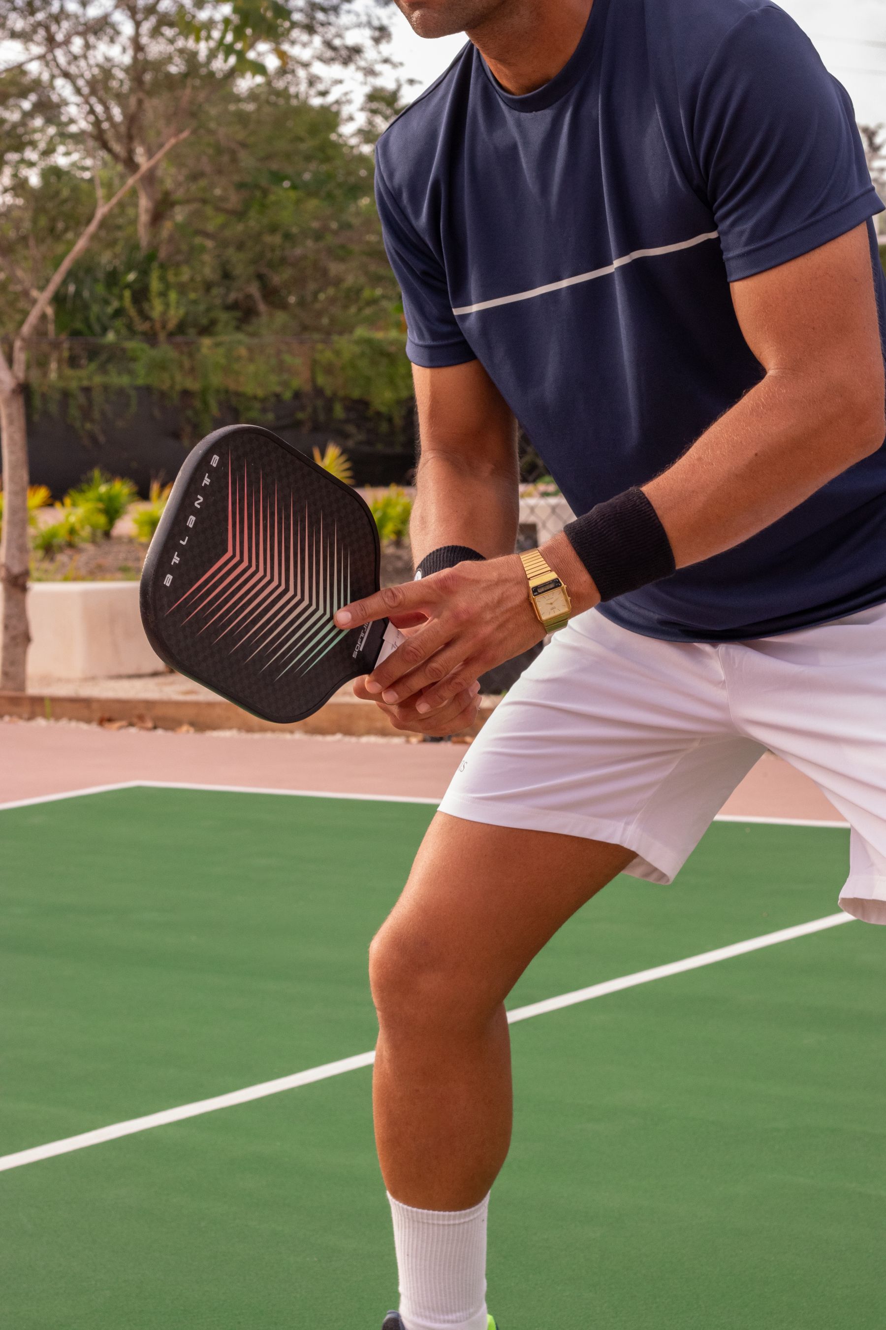 Pickleball player holding a paddle on an outdoor court