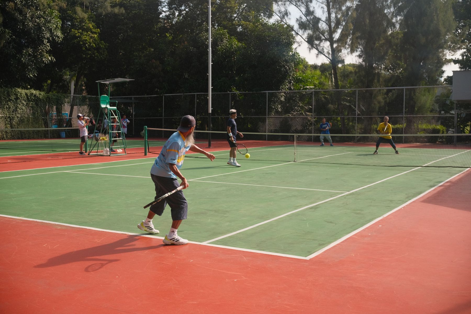 Tennis players enjoying doubles on an outdoor court